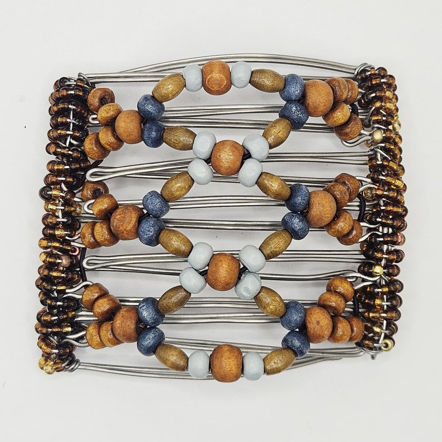 7 Tooth medium Hair comb, Brown and blue neutral wood.