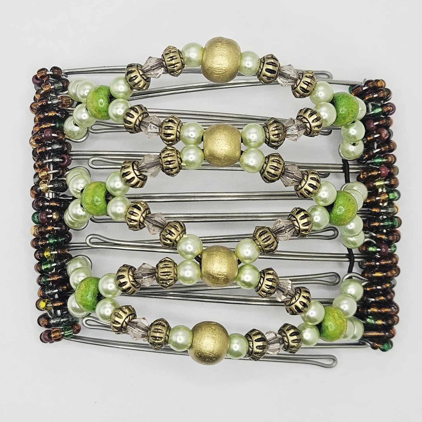 7 Tooth medium Hair comb, Ornamental golds and mixed shades of greens,